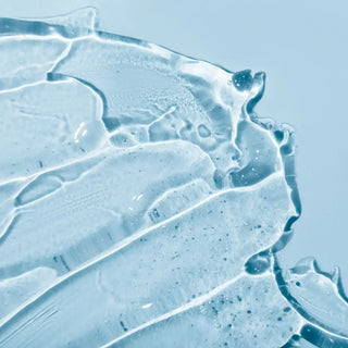 Top view of hair serum in a blue background