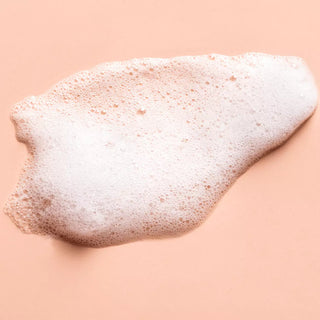 Top view of cleanser foam in a pink background