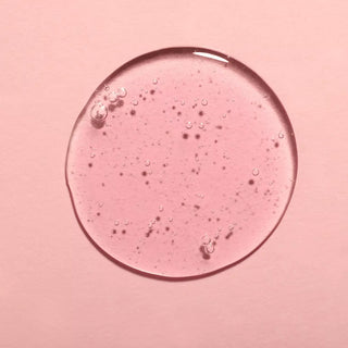 Top view of keratine liquid in a pink background